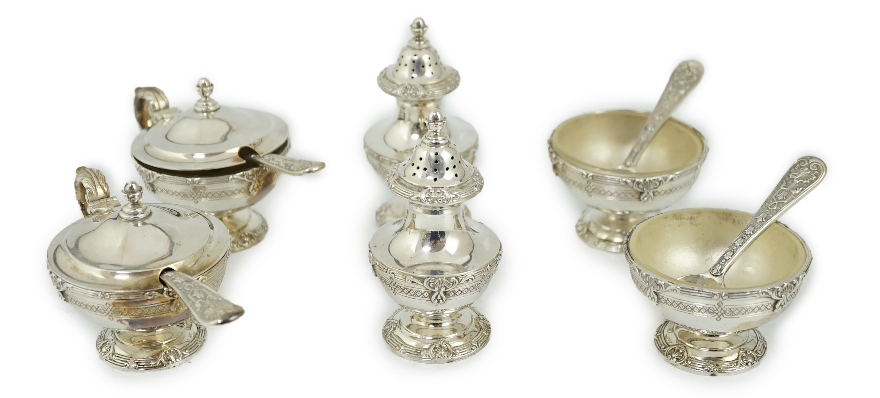 An Elizabeth II cased silver six piece pedestal condiment set, with four matching spoons, by Garrard & Co